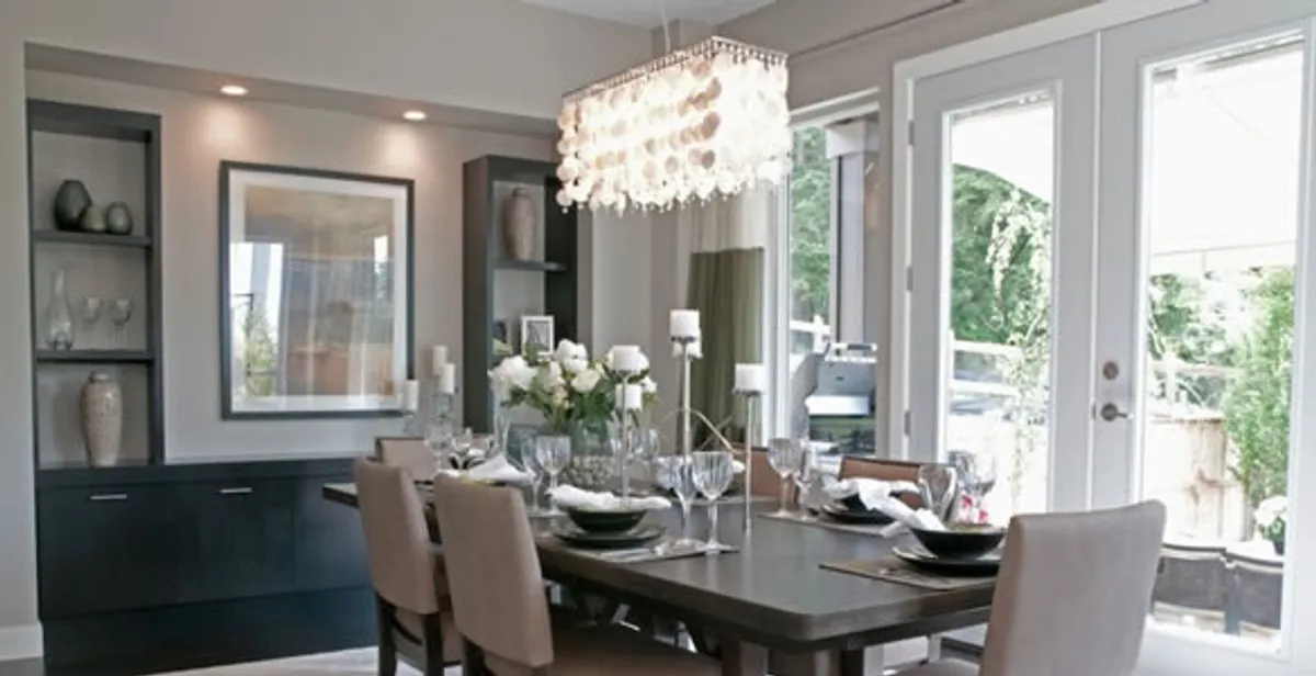 Elegant dining room chandelier installation above table in Wilmington, NC