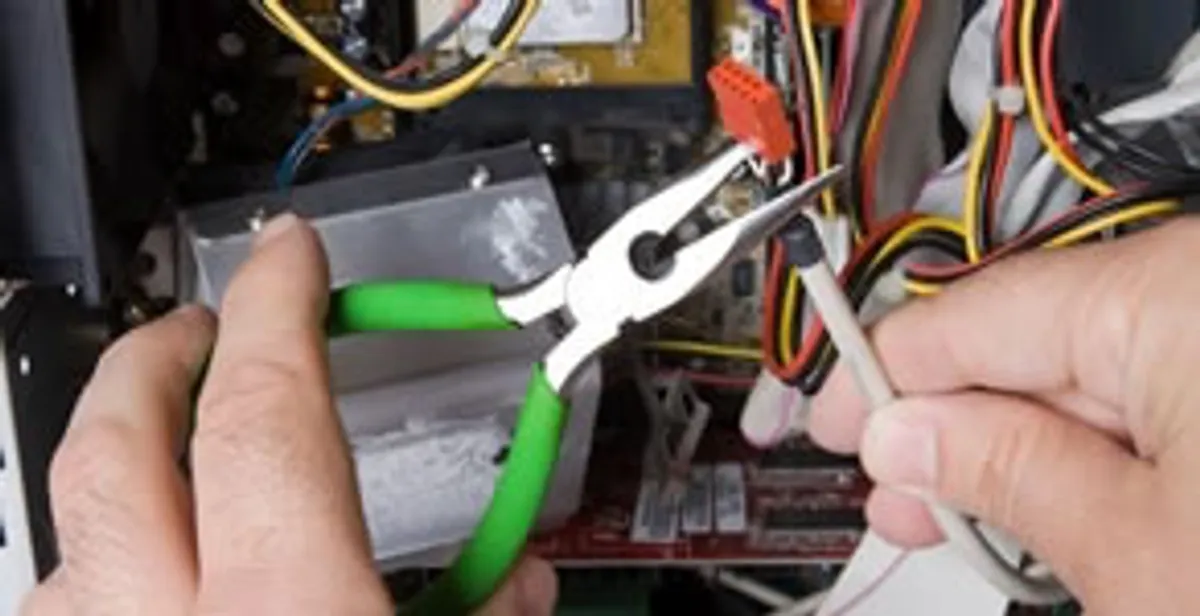 Licensed electrical contractor performing electrical repair with tools in Leland, NC